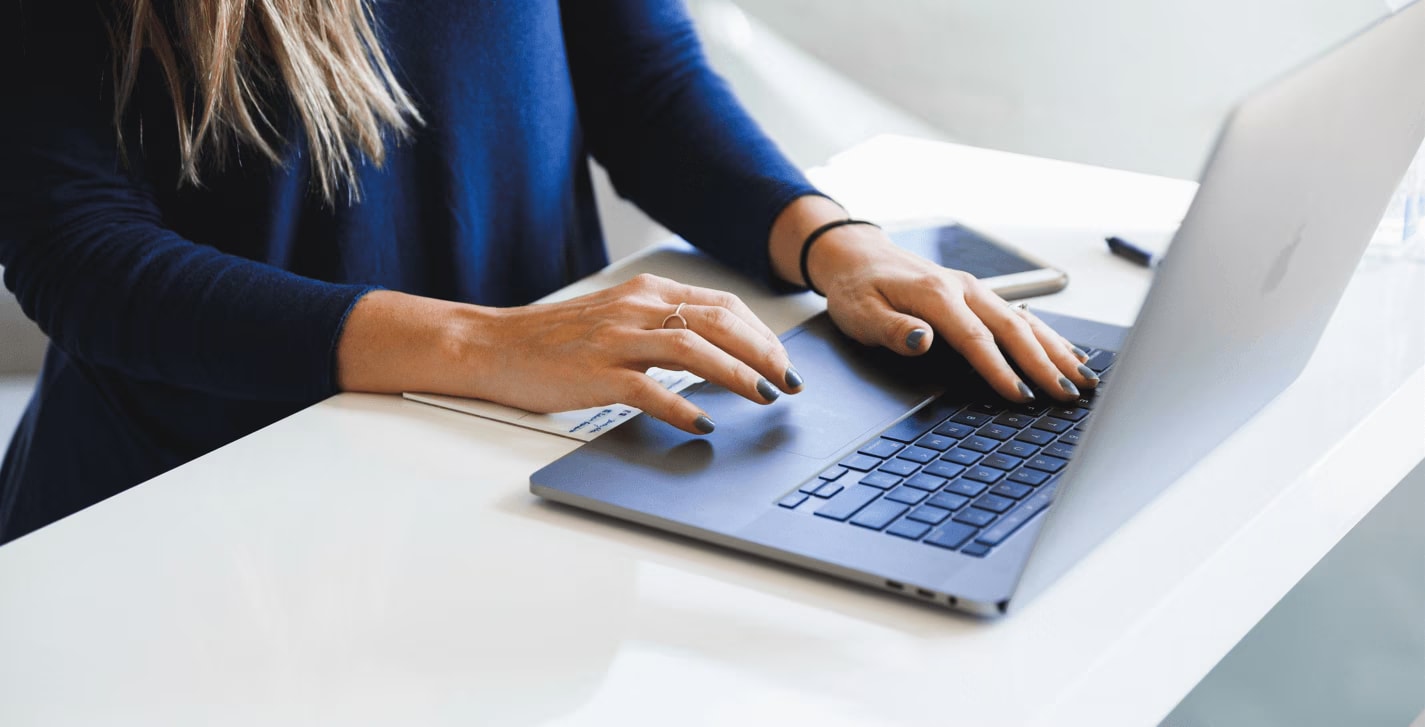 Person using a laptop to search for hotels